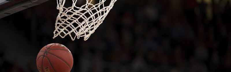 篮球运动员在比赛中扣篮，观众在背景中欢呼